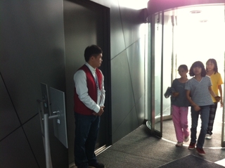 簡瑋男站在側門，關照遊客的安全與需要（蔡幼芬 攝）
