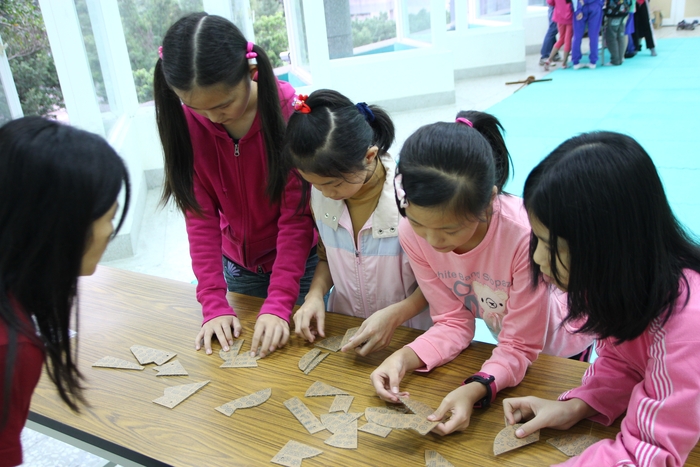 依照陶罐形狀及上面的花紋，拼出幾何印紋陶罐來，一來複習剛剛所學的，二來可以體會考古學家復原文物的工作。